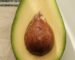 Close-up of a ripe avocado sliced in half showcasing its seed.